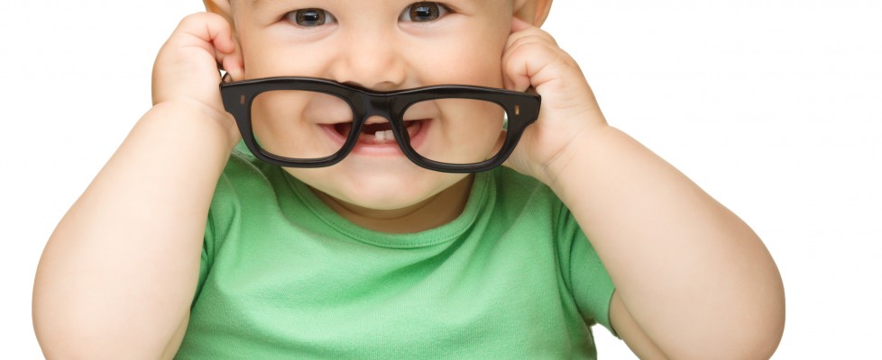 Little child play with book and glasses